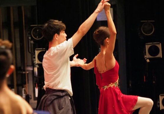 Dance partners performing a lift on stage